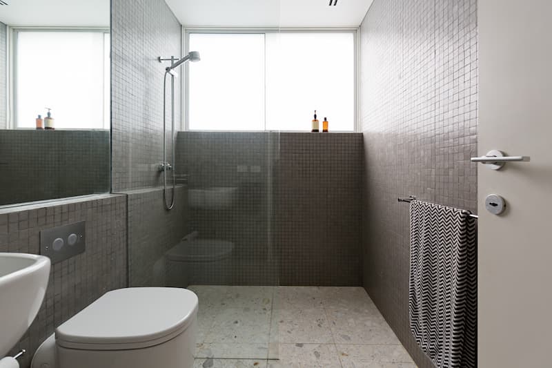 Modern walk in shower with mosaic full height tiles