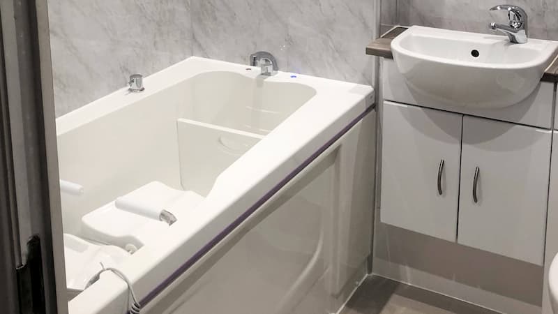 White bath with disabled seating assistance