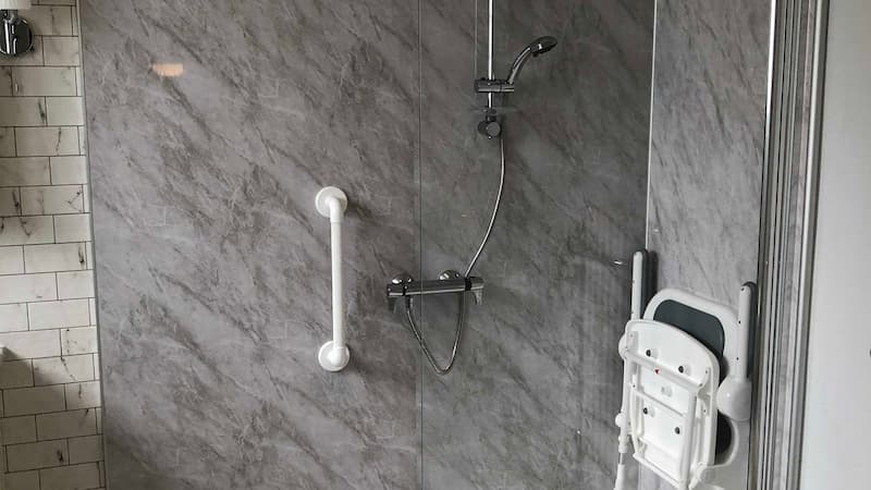 Shower with handrails and seat