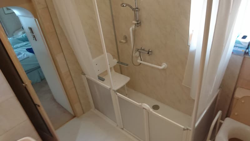 Walk in shower with seat and handrails