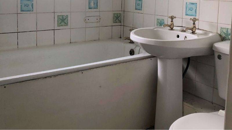 Small bathroom with toilet and walk in shower